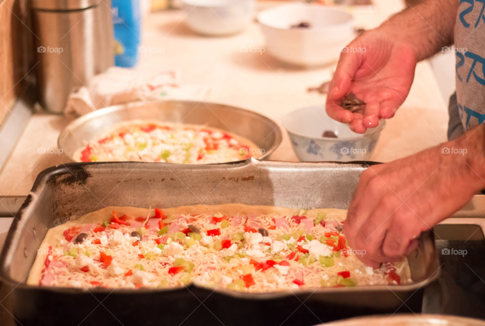 Man Prepares And Cooking Pizza At Home