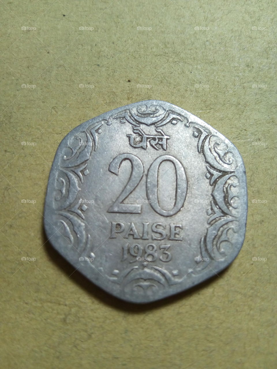 A coin of twenty paise- 1/5 share of Indian Rupee issued by Government of India in 1983.