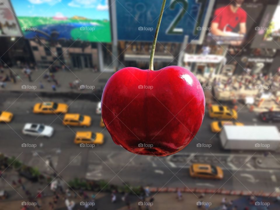 A strawberry in Time square. A strawberry in Time square