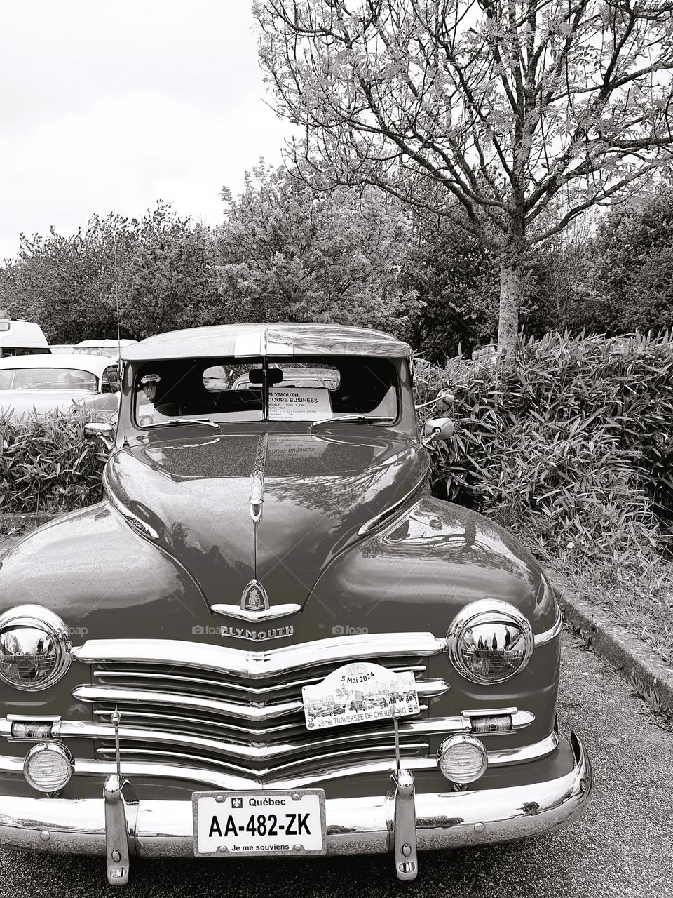 Sepia shot of the front of a Plymouth at Cherbourg car show