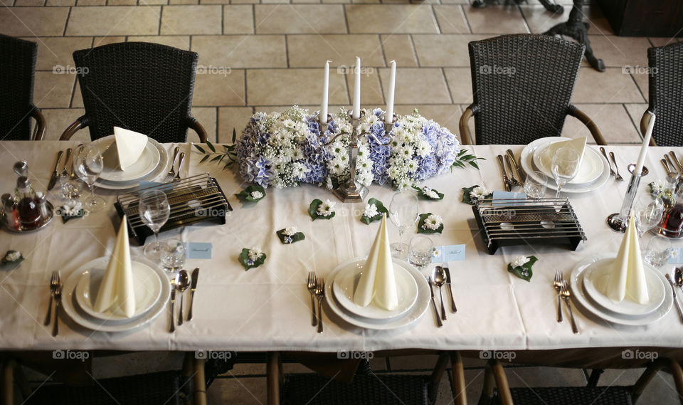 table set wedding decoration. table with flowers, candles napkin on plate