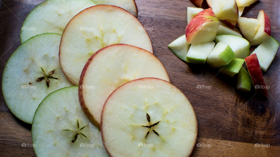 Beautiful still life if red and green sliced apples with star shaped seeds and chopped apple Pieces for making salad or apple pie healthy eating and lifestyle food photography