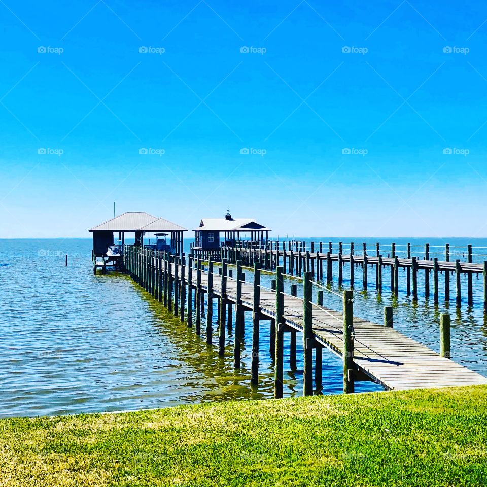 Jetty and pier over the water with blue sky