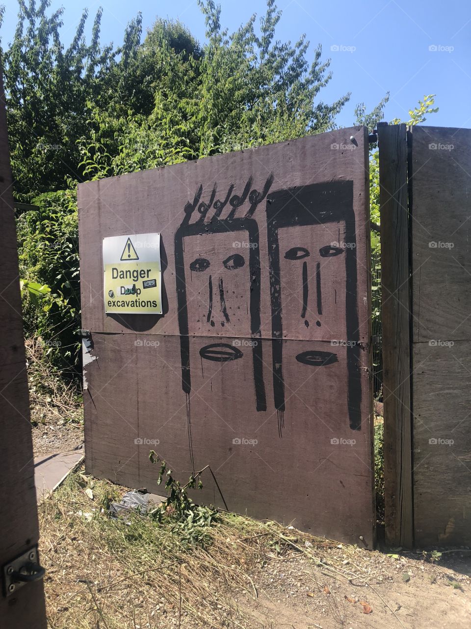 Rusty gate with street art in west London 