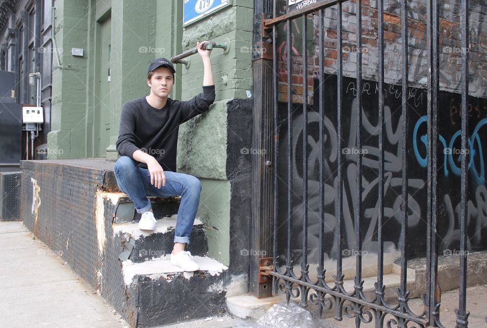 Young man sitting on staircase