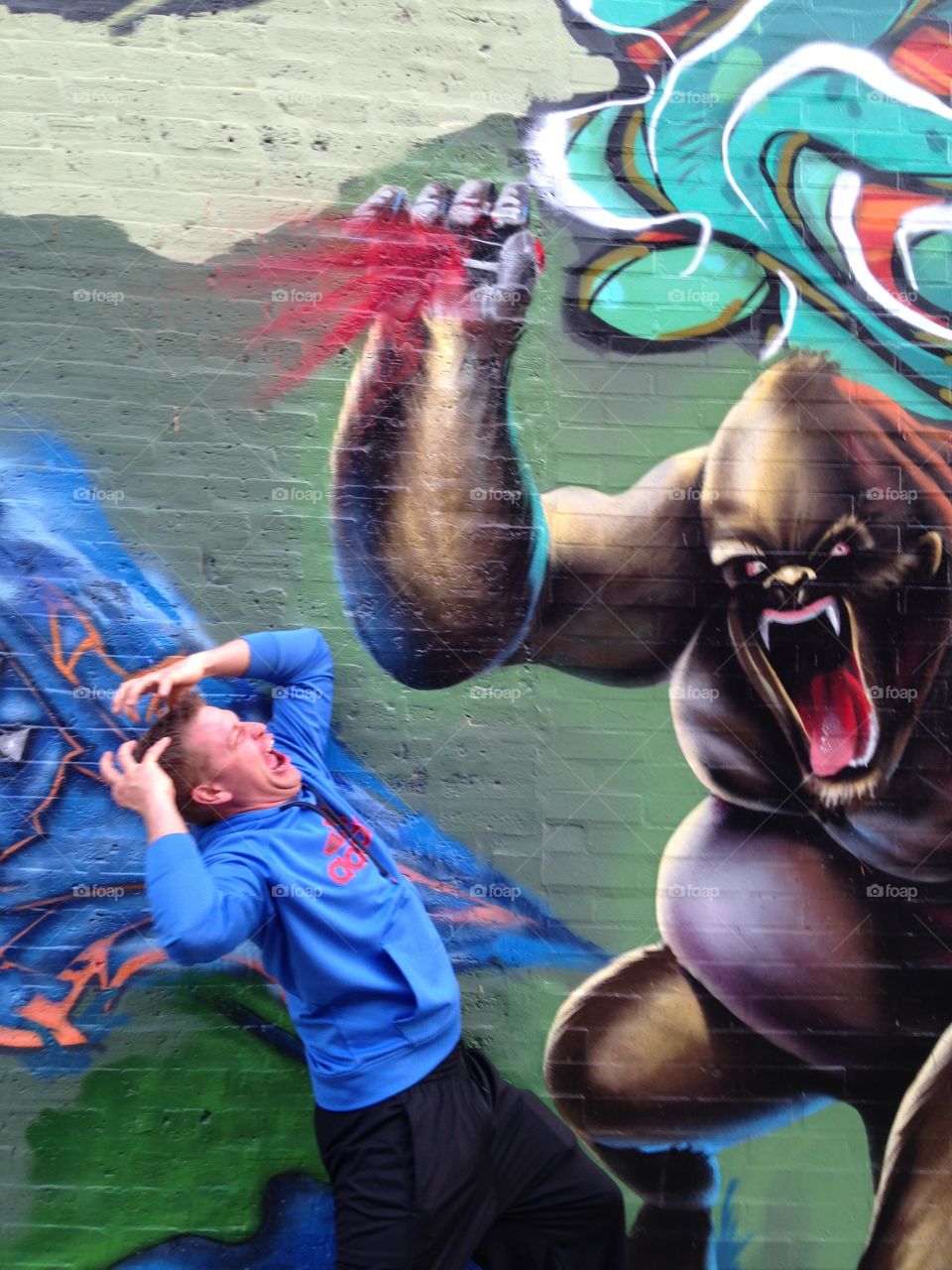 Ape Attack. City wall art comes to life...ape attacking a human 