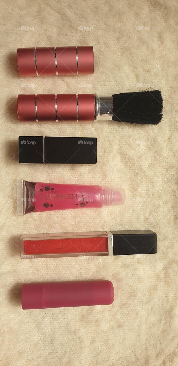 beautiful beauty accessories for ladies, lipstick, gloss, brush, and the mirror that cannot be missing.