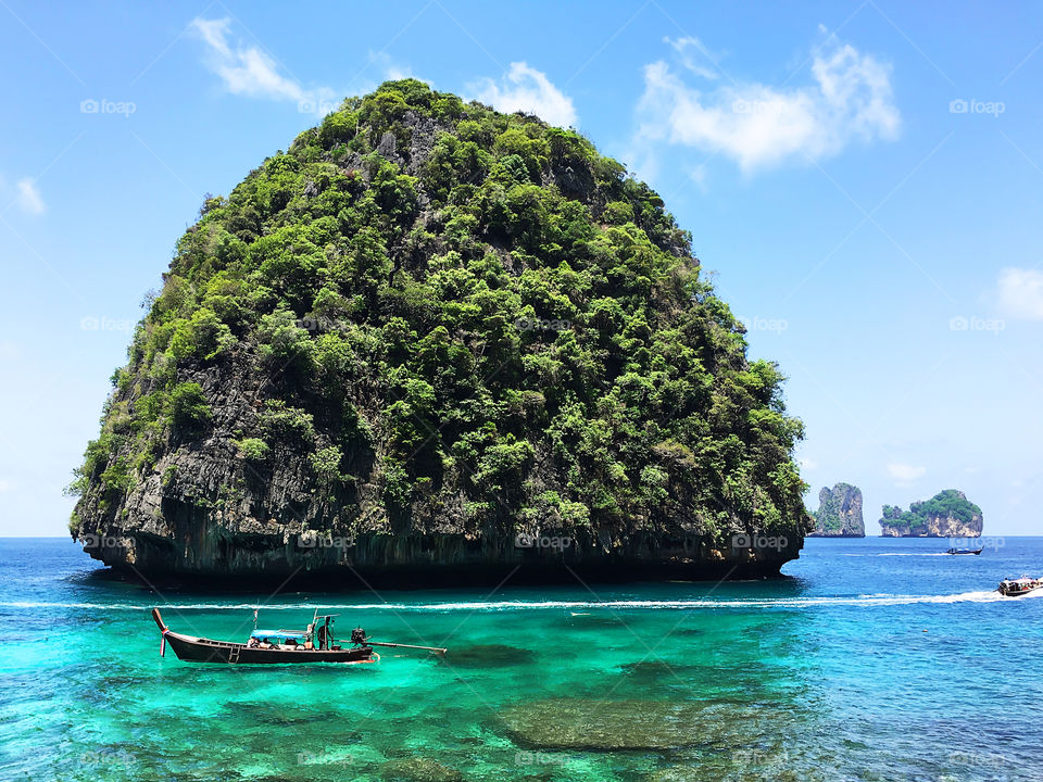Beautiful green island in clear turquoise sea water in Thailand 