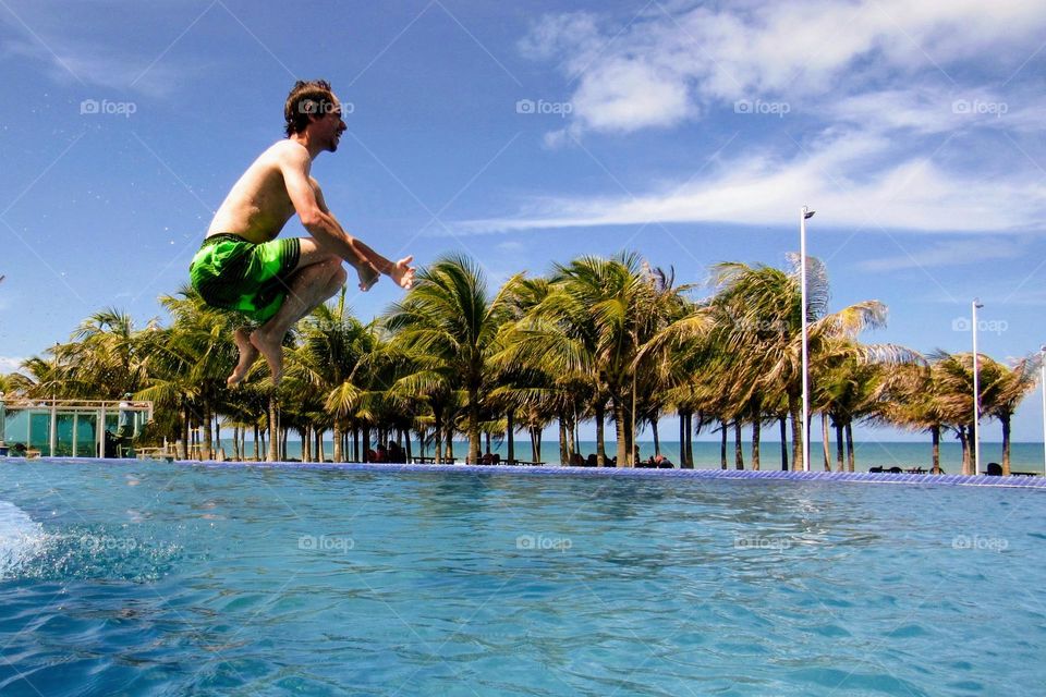 Boy jumping in the pool