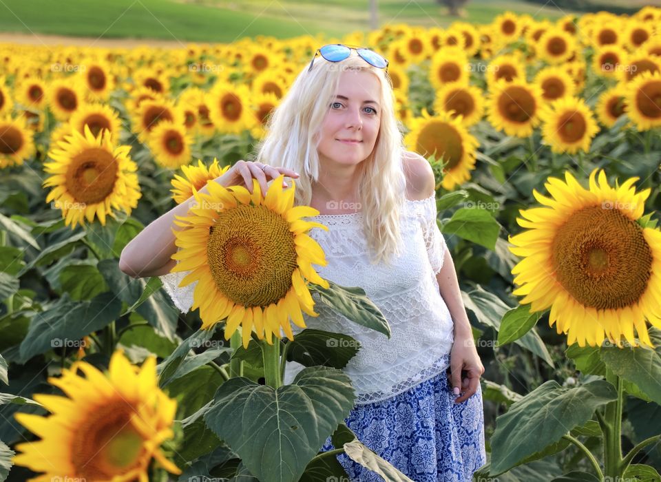 Blonde in a field of sunflowers