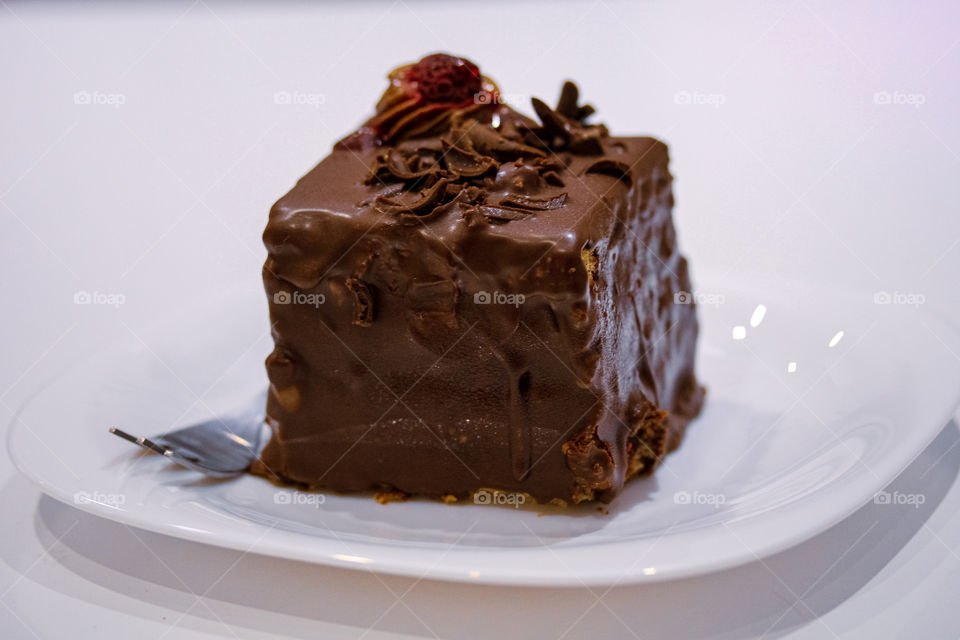 Chocolate mousse with raspberries on a white plate