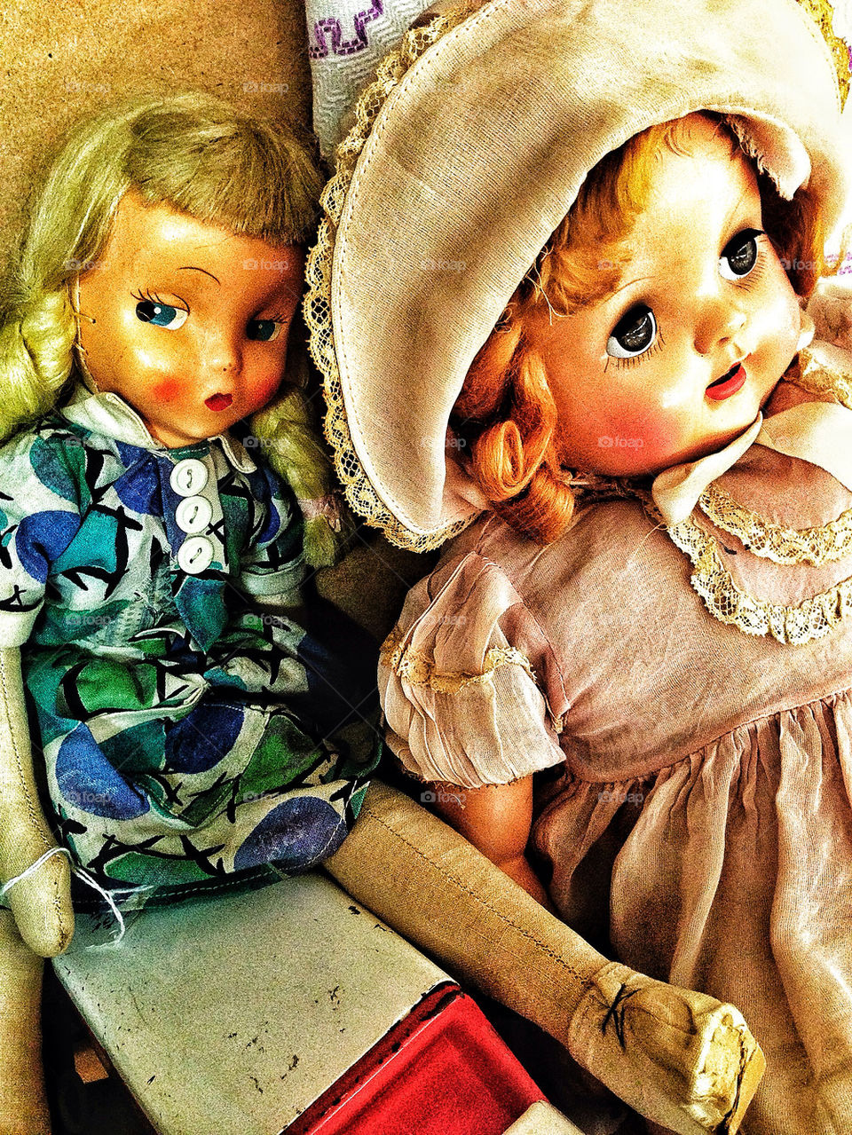 Pair of antique American dolls looking mischievous