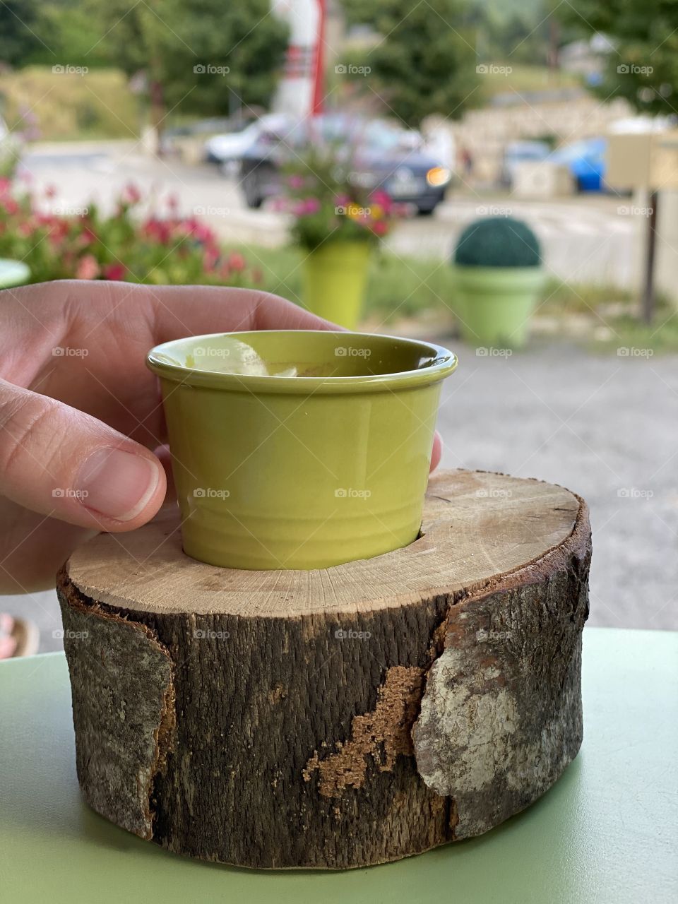 A hand grabbing for a coffe outside a coffee shop