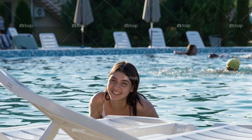 A laughing girl in a pool 