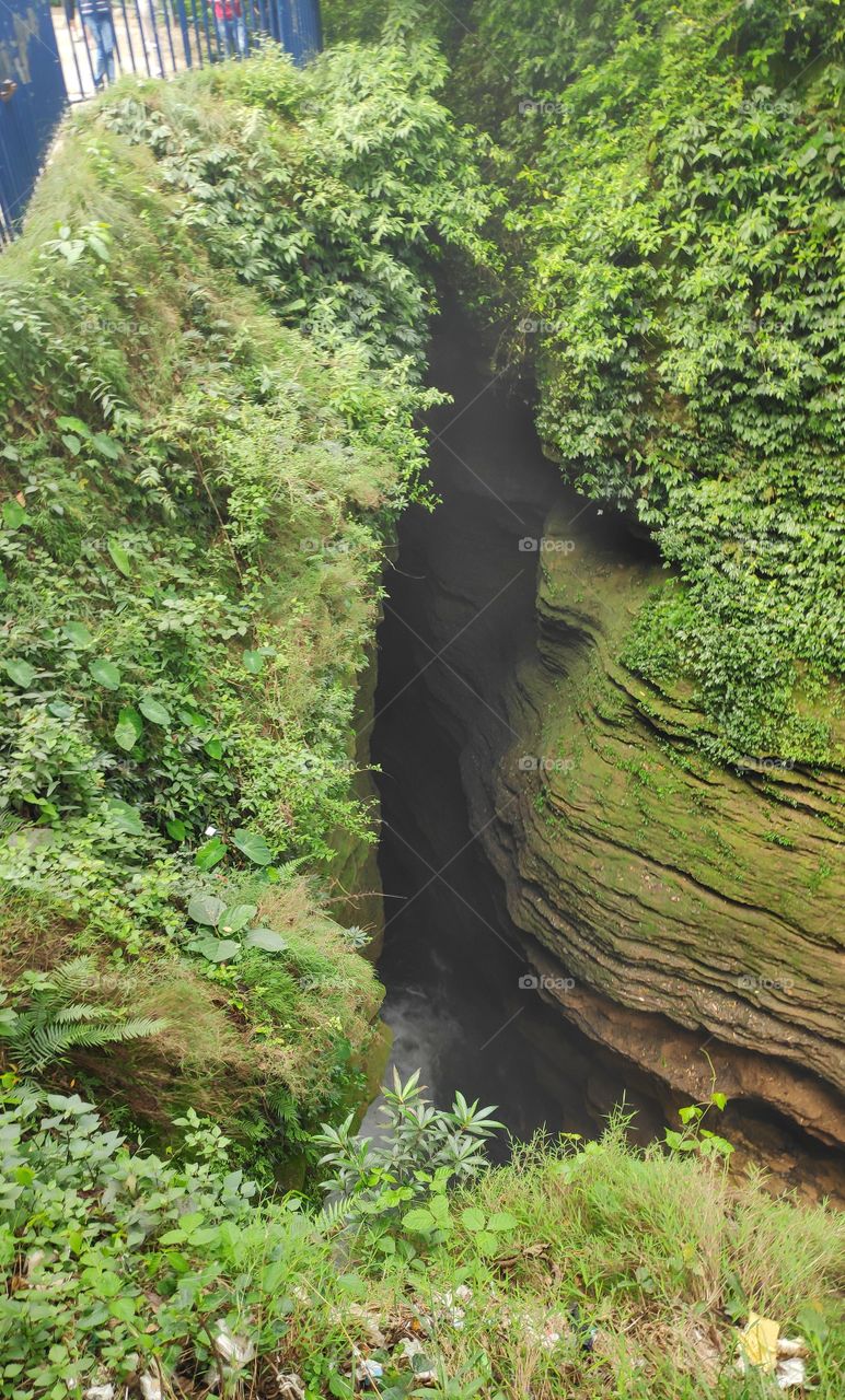 Davis fall situated in Nepal. the IMG is of the way through which the river passes under the city Pokhara of Nepal.