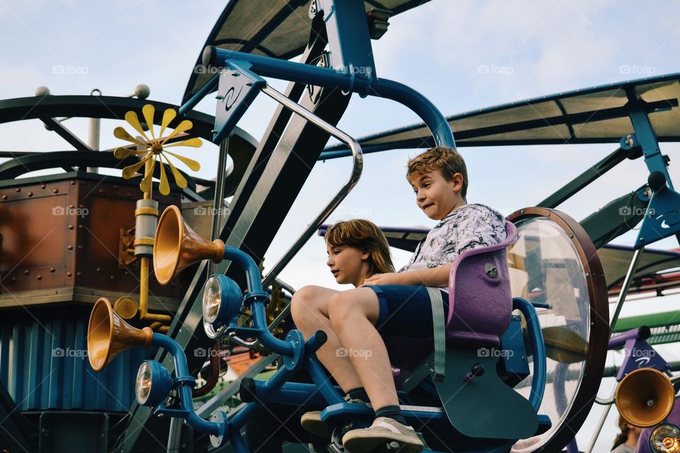 Two teenagers having fun in the amusement park