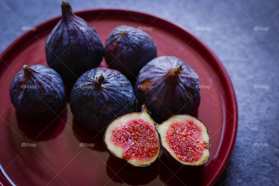 fresh figs on a burgundy plate