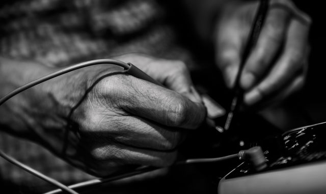 Technician using multi meter in workshop