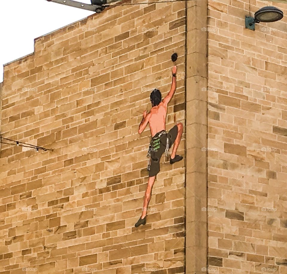 Wall art mural rock climber on Brick wall