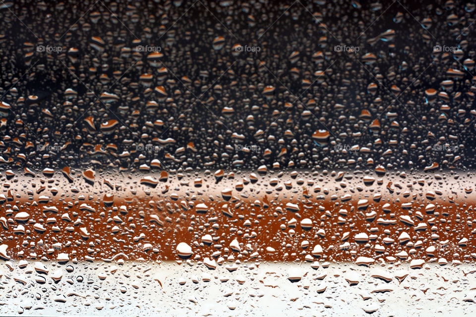 Raindrops on the window. Blurred photos background.