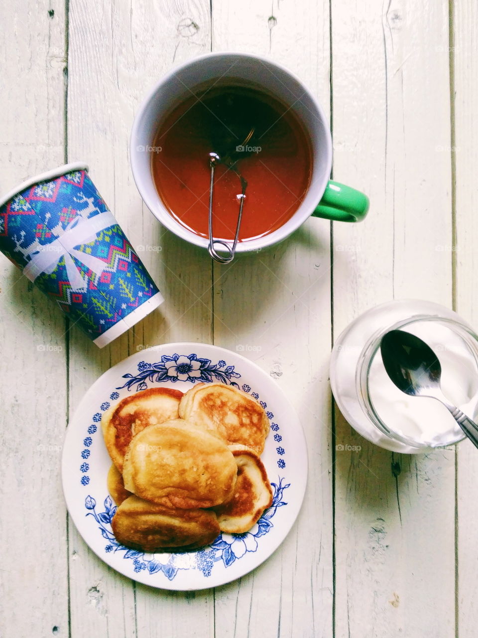 homemade pancakes, a cup of tea and sour cream for breakfast