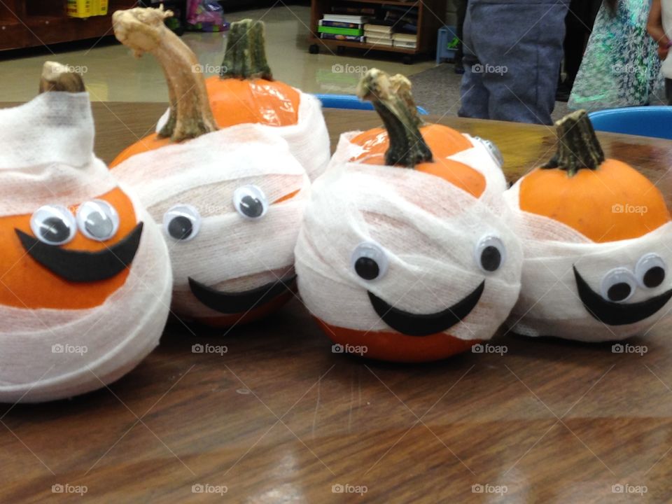 Mummy decorated pumpkins that the preschool and elementary school children made during arts and crafts for Halloween. 