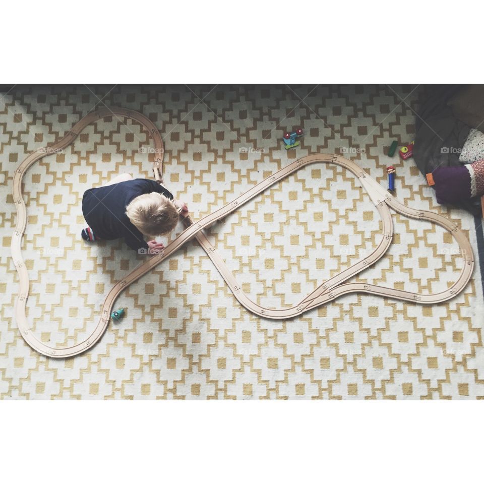 Wooden toy train. Child playing with a wooden train