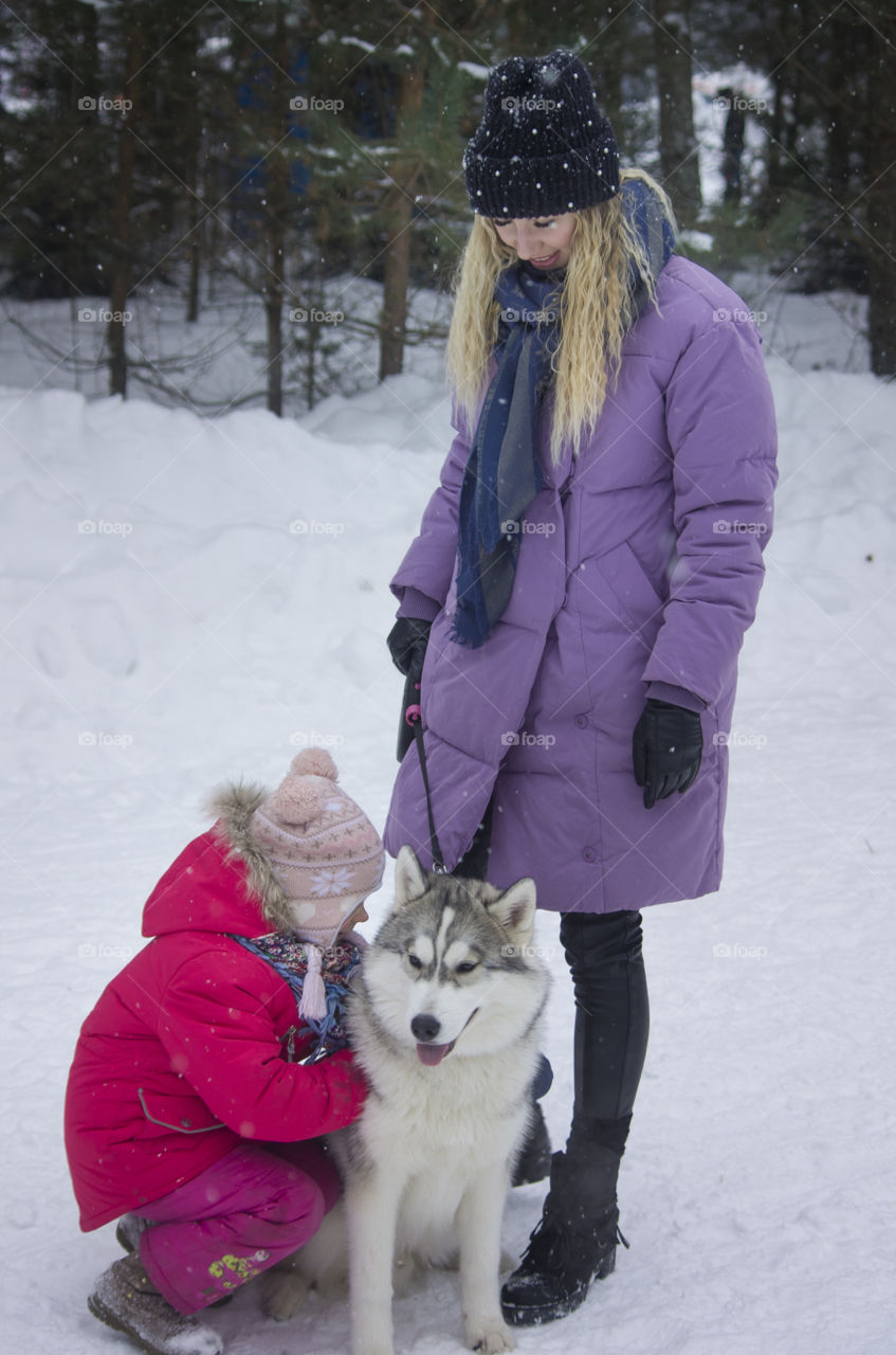 mother with daughter and dog husky