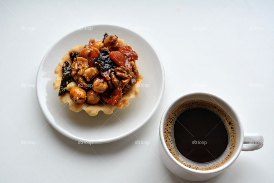 coffee cup with cake top view on a white background