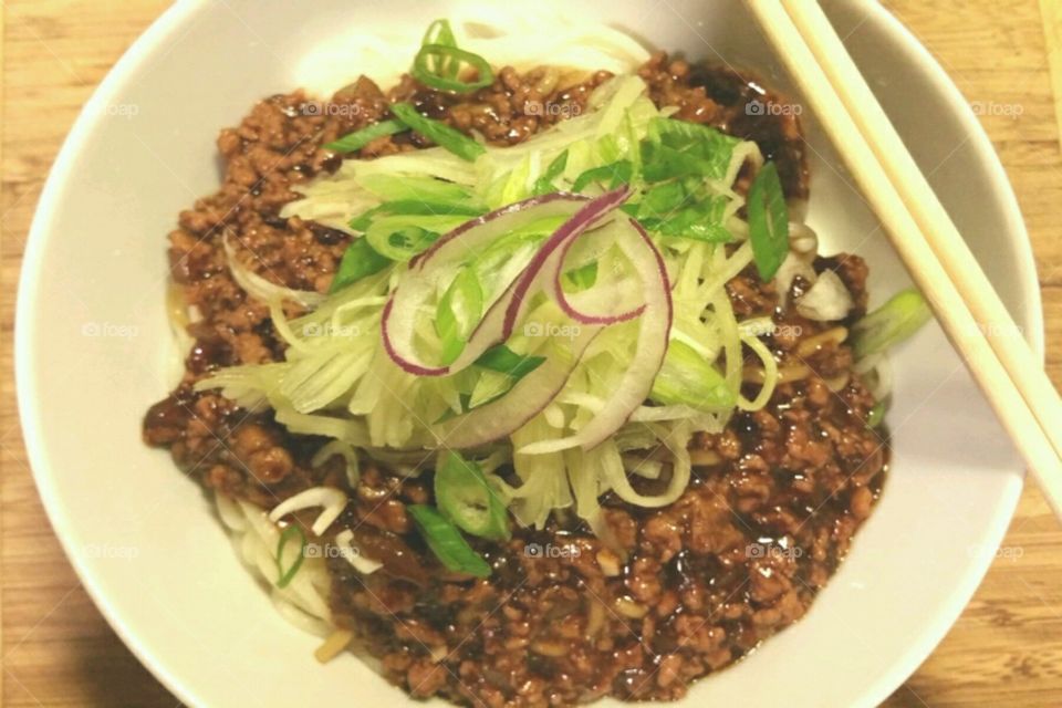 Asian Cold Noodles - ground pork with garlic in soy base topped cucumbers, scallions and red onion.