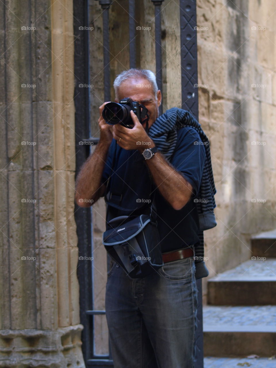 Senior man photographing with camera