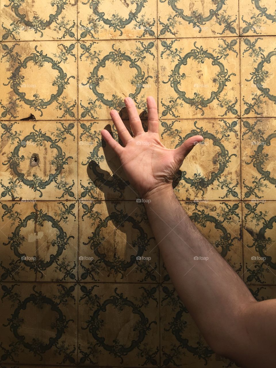 Vintage wall tiles with a man hand