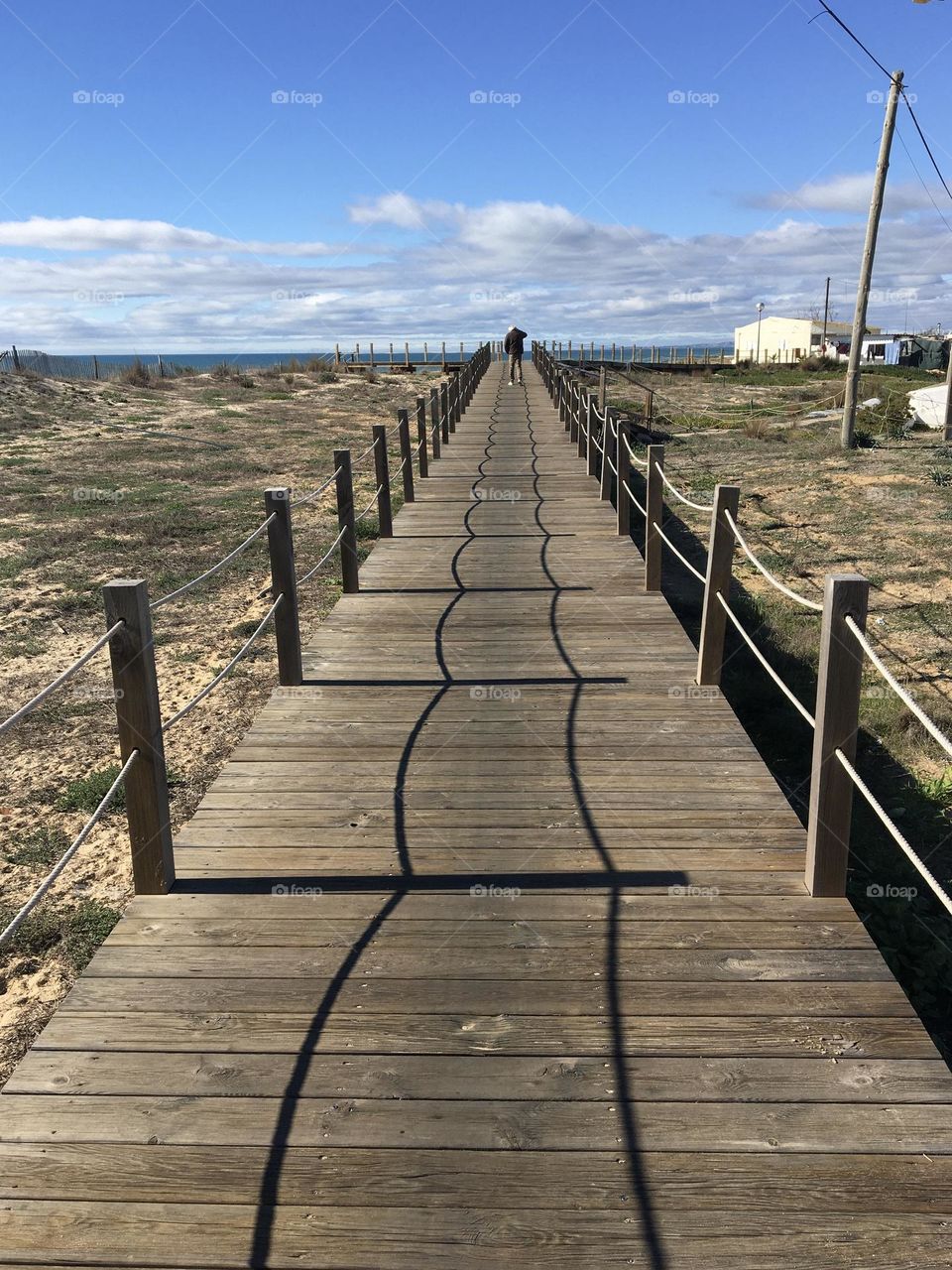 Shadow pattern on wooden walkway in dunes