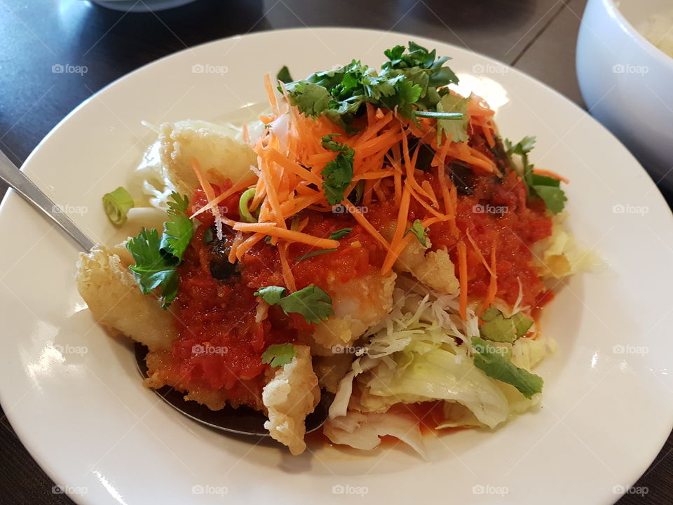 Sweet and sour fish fillet with salad