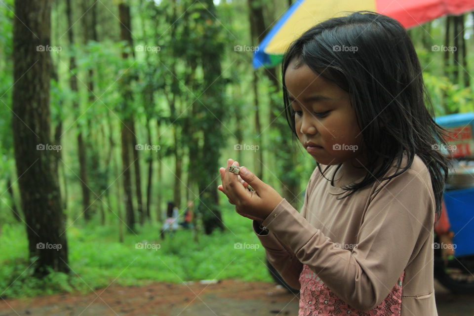 Asian girl playing in forest