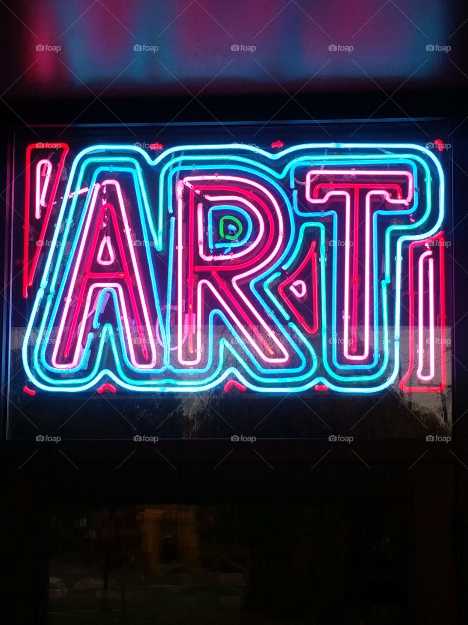 neon sign that says "art"