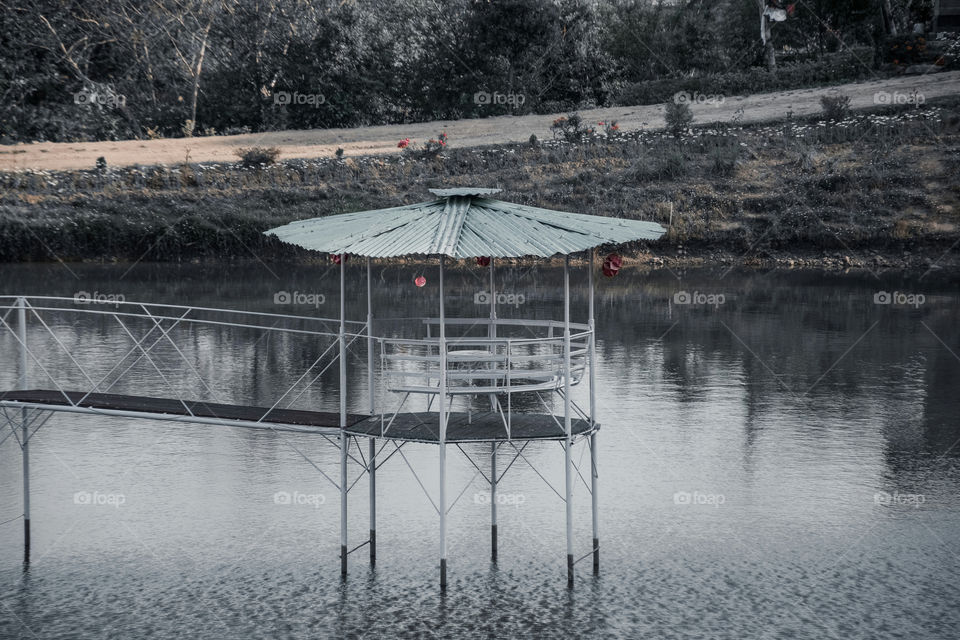 Structure in the middle of a man-made pond.