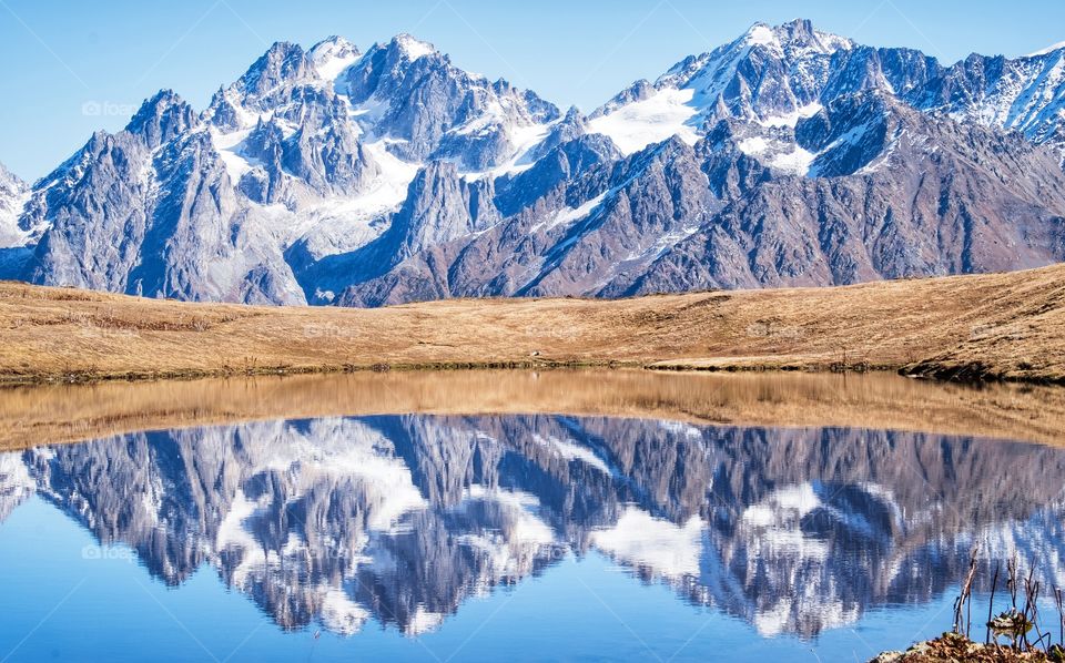 The perfect reflection of the mountains in the lake in Georgia