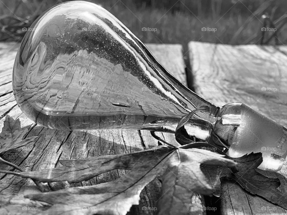 A bauble in the mid-morning sun. Glass, with the Autumn leaves, reflecting in the sun. 