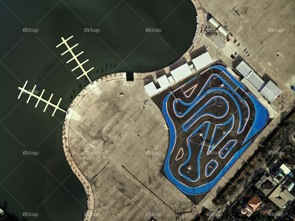 go kart racing track near a lake view from above