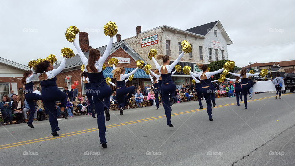 Dance squad does a performance during a fall festival parade.