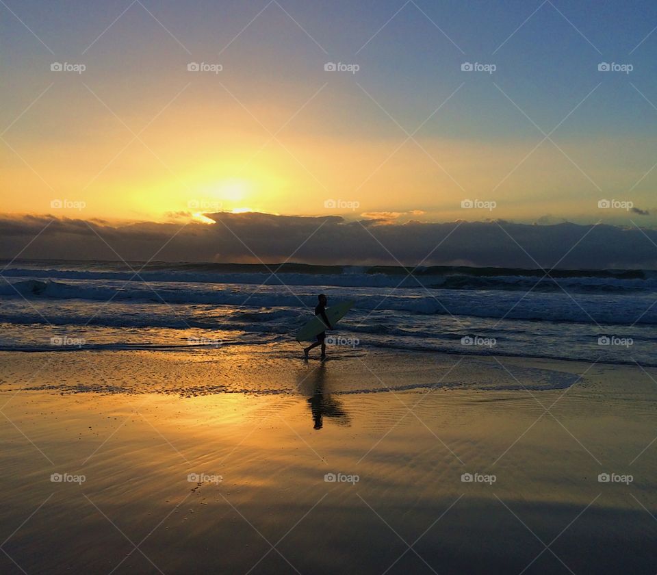 Beautiful golden orange beach surfer sunrise 