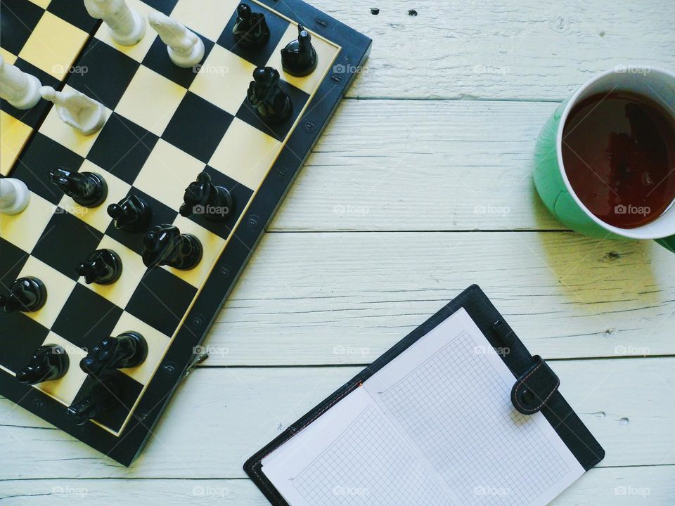 chess, a cup of tea and a notebook