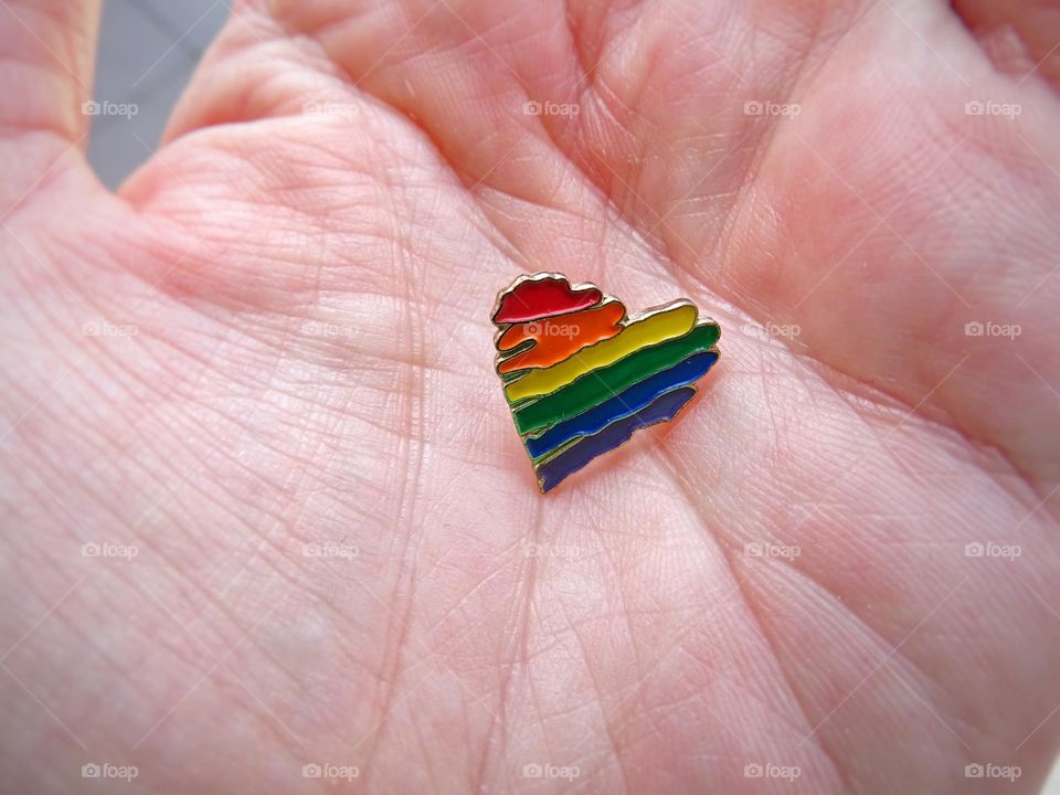 Pride pin in hand