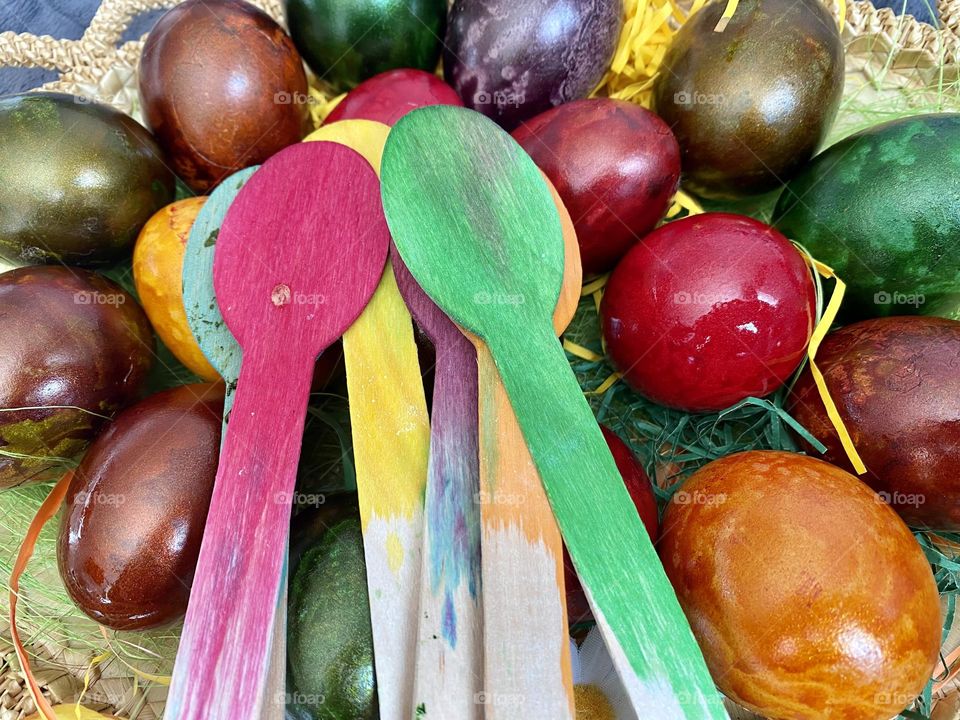 Colourful eggs and dyed wooden spoons 