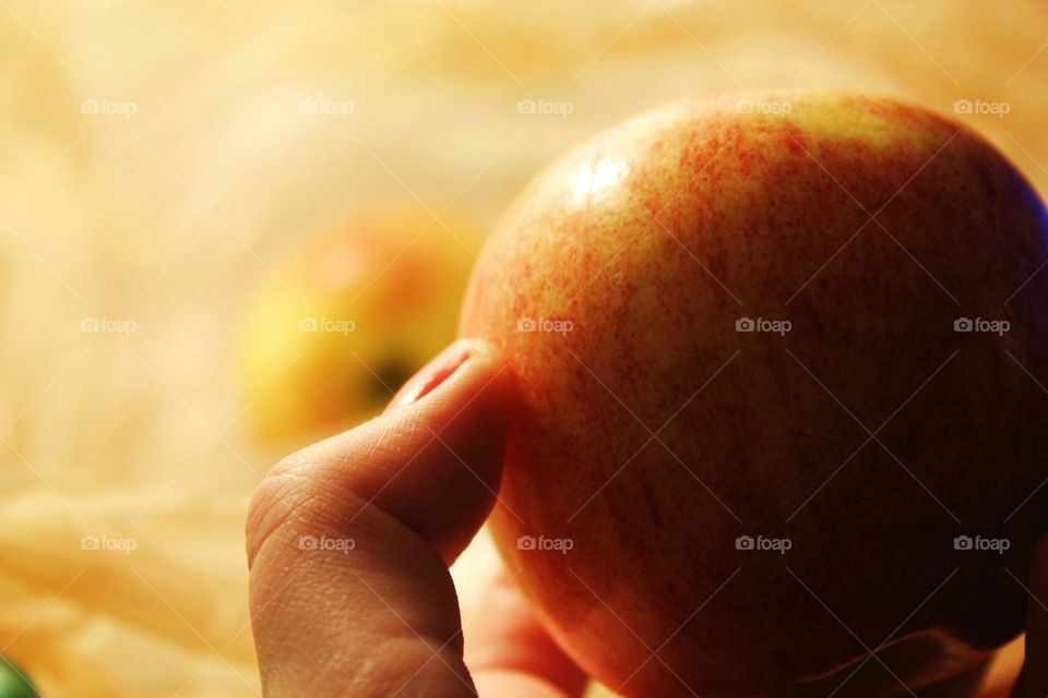 Close-up of apple holding in hand