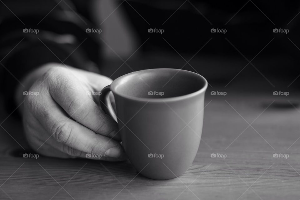 Hand holding a mug