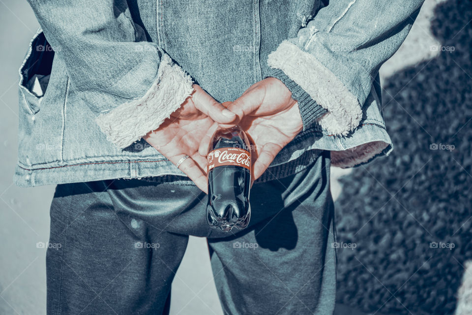 A random candid shot of a guy holding his coca cola!