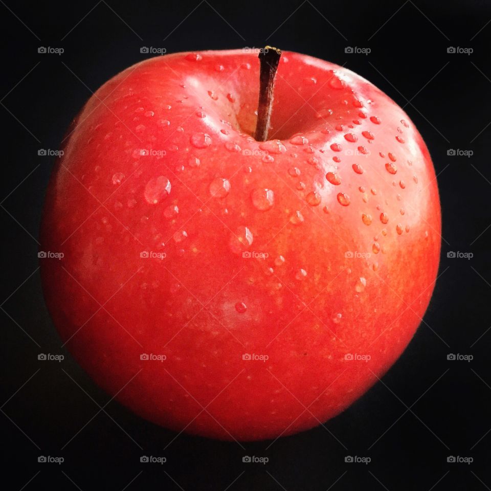 Red apple on black background