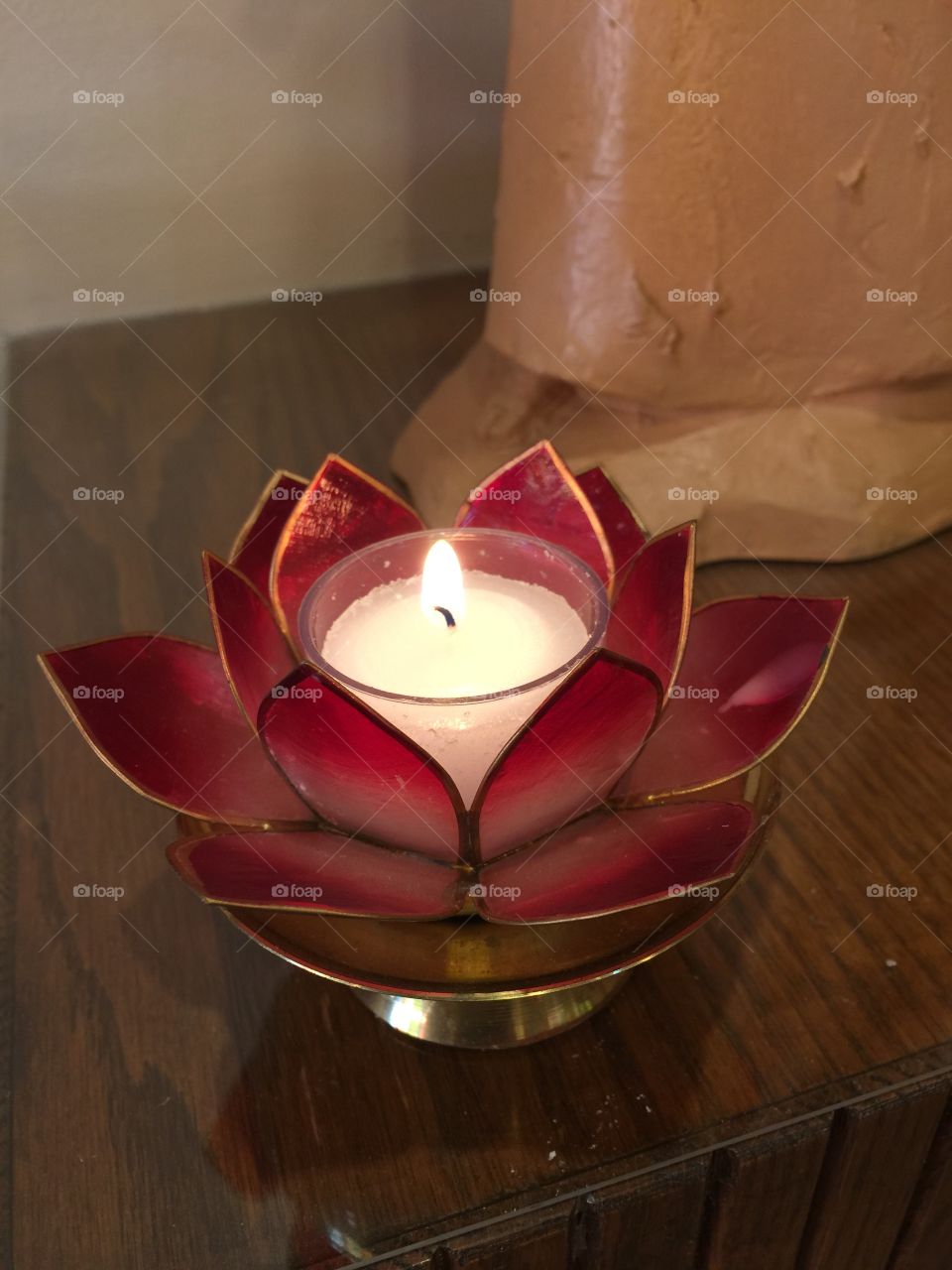 Candle in red petal holder